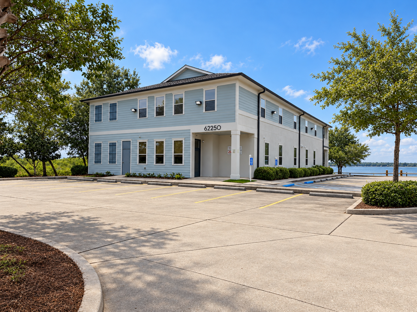 Lakeshore Parc's blue office building with a covered entrance and parking
